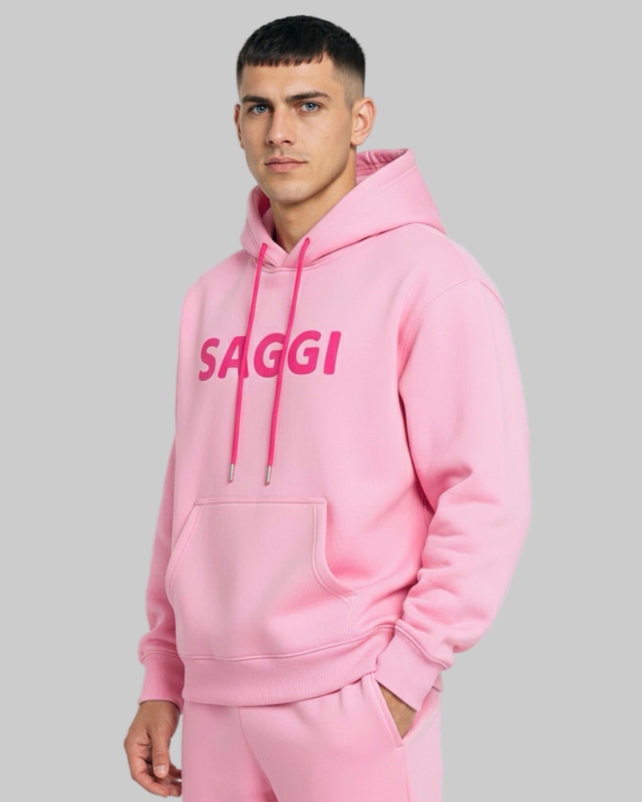 Model wearing pink SAGGI heavyweight graphic hoodie with fuchsia logo and fuchsia drawstrings, true-to-size fit.
