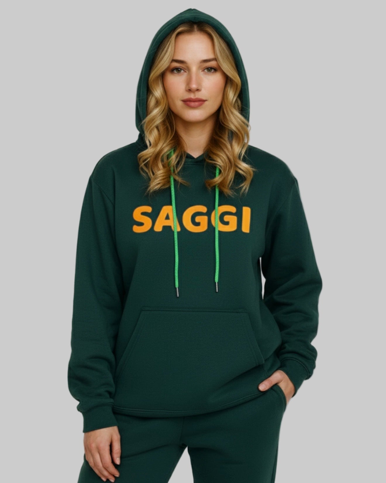 Model wearing forest green SAGGI heavyweight graphic hoodie with orange logo and green drawstrings, true-to-size fit.