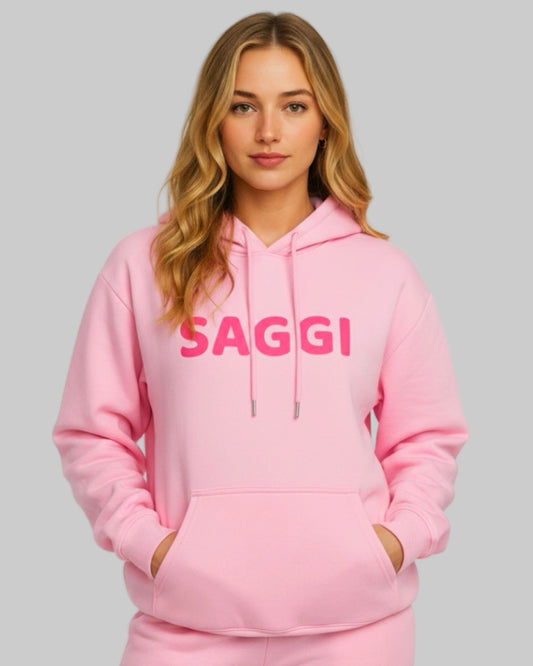 Model wearing pink SAGGI heavyweight graphic hoodie with fuchsia logo and pink drawstrings, true-to-size fit.