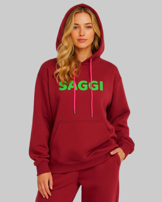 Model wearing burgundy SAGGI heavyweight graphic hoodie with green logo and fuchsia drawstrings, true-to-size fit.