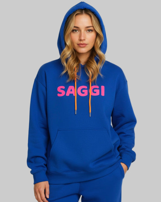 Model wearing royal blue SAGGI heavyweight graphic hoodie with fuchsia logo and orange drawstrings, true-to-size fit.