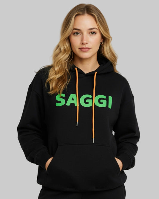 Model wearing black SAGGI heavyweight graphic hoodie with green logo and orange drawstrings, true-to-size fit.