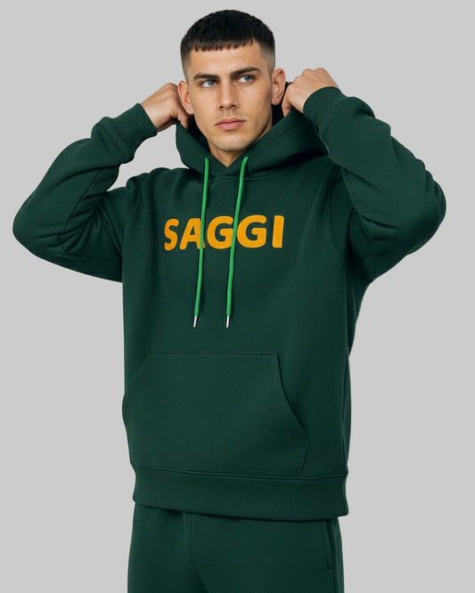 Model wearing forest green SAGGI heavyweight graphic hoodie with orange logo and green drawstrings, true-to-size fit.
