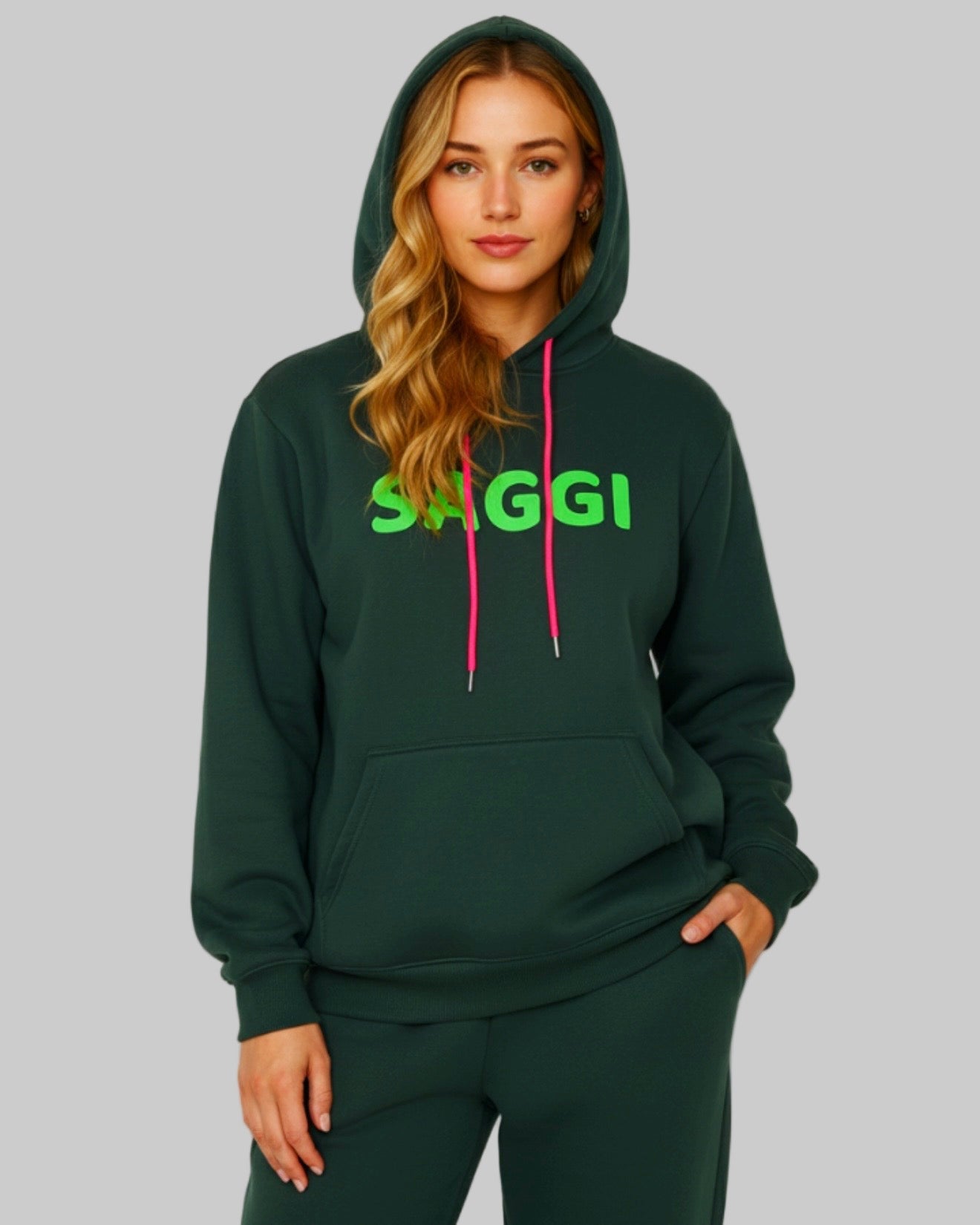 Model wearing forest green SAGGI heavyweight graphic hoodie with green logo and fuchsia drawstrings, true-to-size fit.