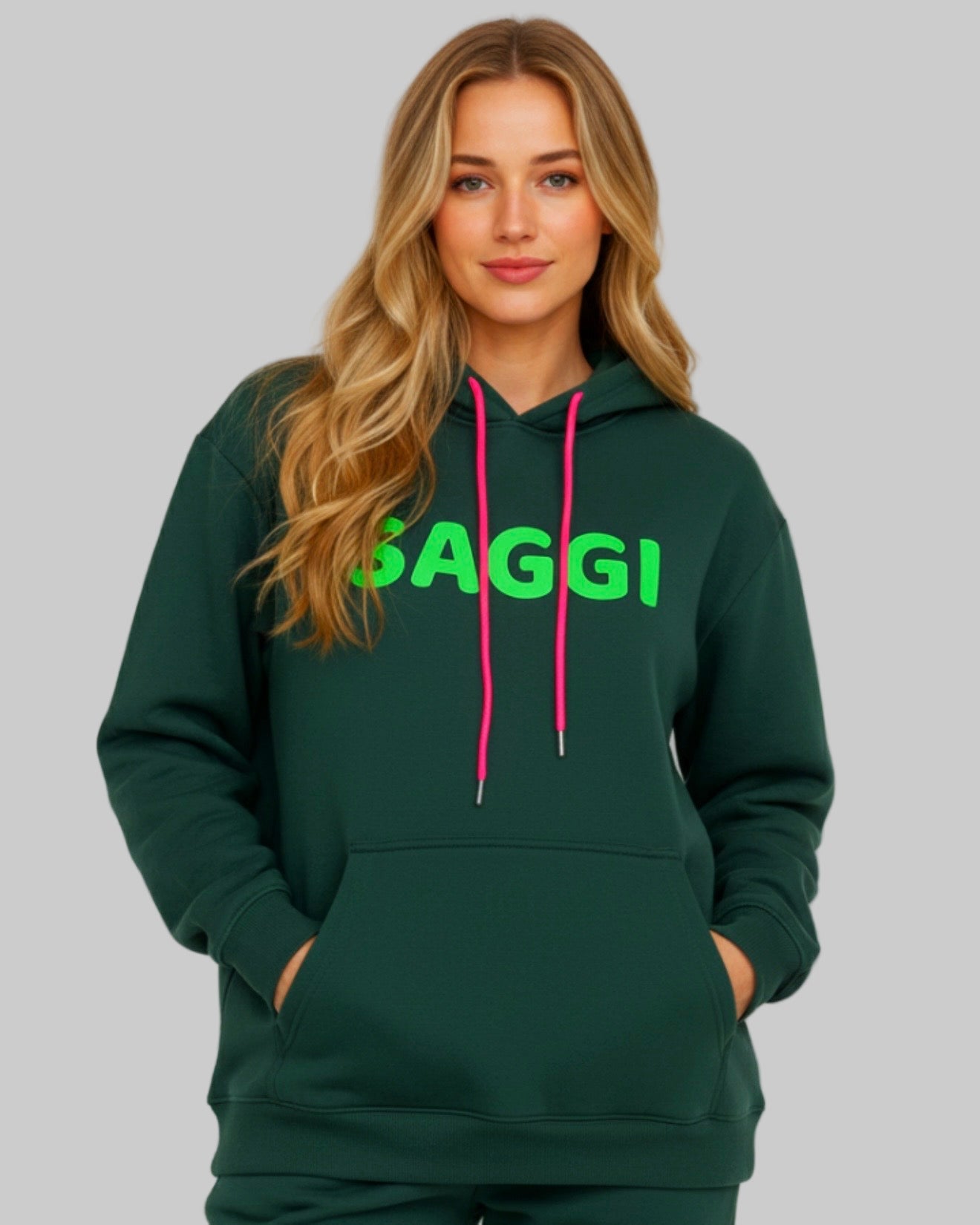 Model wearing forest green SAGGI heavyweight graphic hoodie with green logo and fuchsia drawstrings, true-to-size fit.