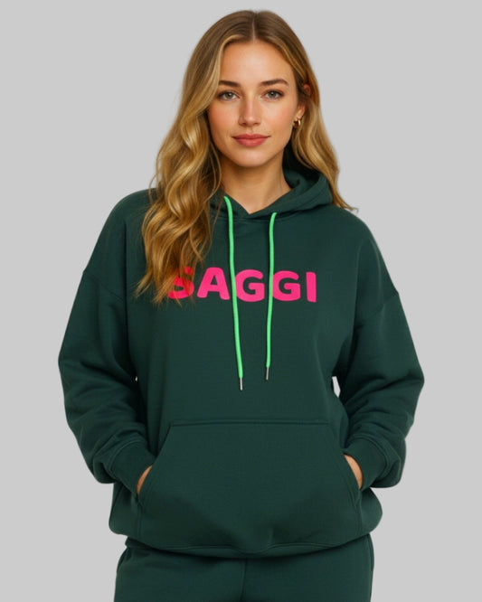 Model wearing forest green SAGGI heavyweight graphic hoodie with fuchsia logo and green drawstrings, true-to-size fit.