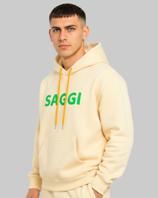 Model wearing khaki SAGGI heavyweight graphic hoodie with green logo and orange drawstrings, true-to-size fit.