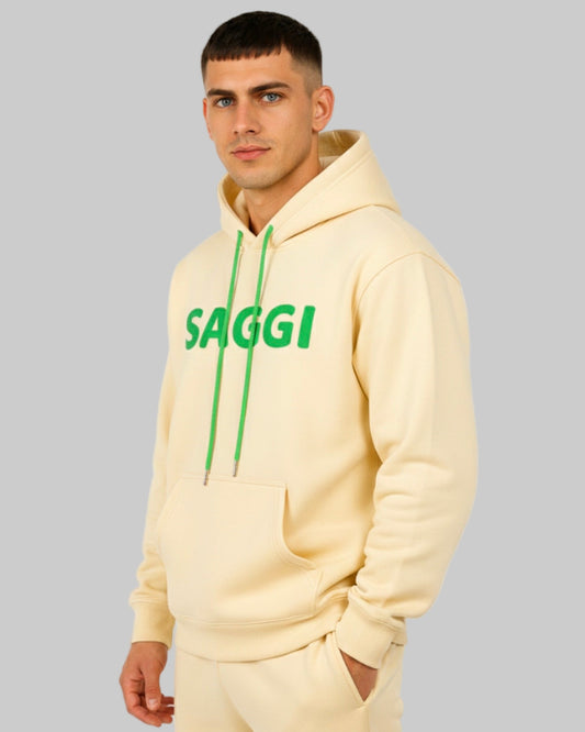 Model wearing khaki SAGGI heavyweight graphic hoodie with green logo and green drawstrings, true-to-size fit.