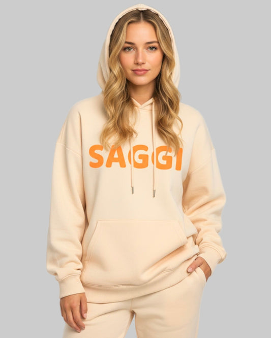 Model wearing khaki SAGGI heavyweight graphic hoodie with orange logo and khaki drawstrings, true-to-size fit.